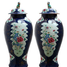 A pair of powder blue jars and covers