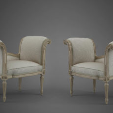 A PAIR OF LOUIS XVI CREAM AND GREY-LACQUERED CARVED BEECHWOOD BANQUETTES