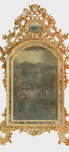 A NORTH ITALIAN CARVED AND GILTWOOD MIRROR